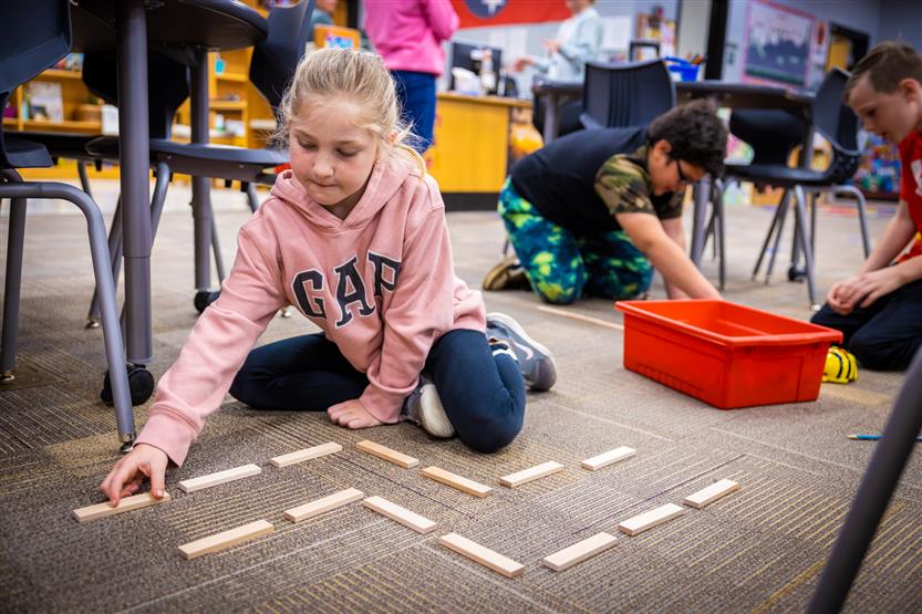 Students use Bee-Bots in the Learning Commons